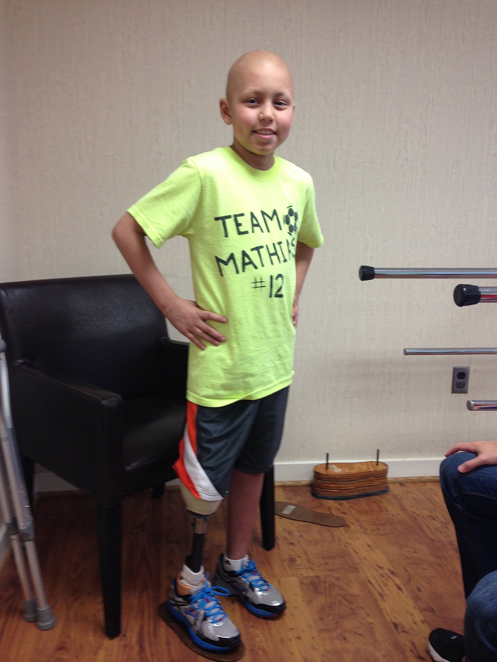 Mathias standing on his prosthetic leg for the first time without assistance